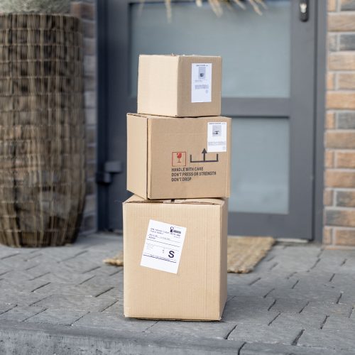 Parcels on the porch in front of the front door. Concept of contactless delivery goods home during a pandemic